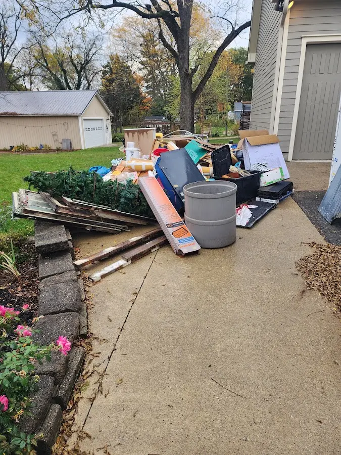 Dumpster being loaded with debris for 3 Yard Dumpster Rental in West Orange